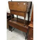 A Victorian drop leaf Pembroke type work table with single drawer and end cupboard door raised on