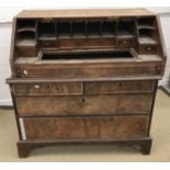 A walnut and feather banded bureau in the early 18th Century manner,