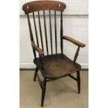 A Victorian beech and elm stick back elbow chair on turned legs united by an H stretcher together