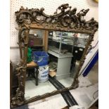 A Victorian gilt framed overmantel mirror with all over scrolling acanthus and flower head