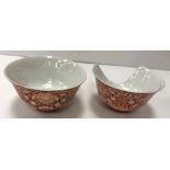 A pair of 19th Century Chinese coral red decorated porcelain bowls of inverted bell form,