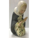 A Lenci pottery figure of the Madonna kneeling, her hands raised before her, signed to base 27.