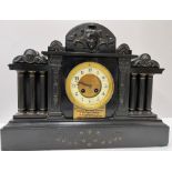 A circa 1900 black marble cased architectural mantle clock with column decoration and eight day