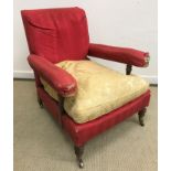 A Victorian upholstered open arm chair by Howard of London,