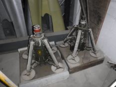 A pair of pneumatic jacks, the heavy duty cylinders on four supporting arms,
