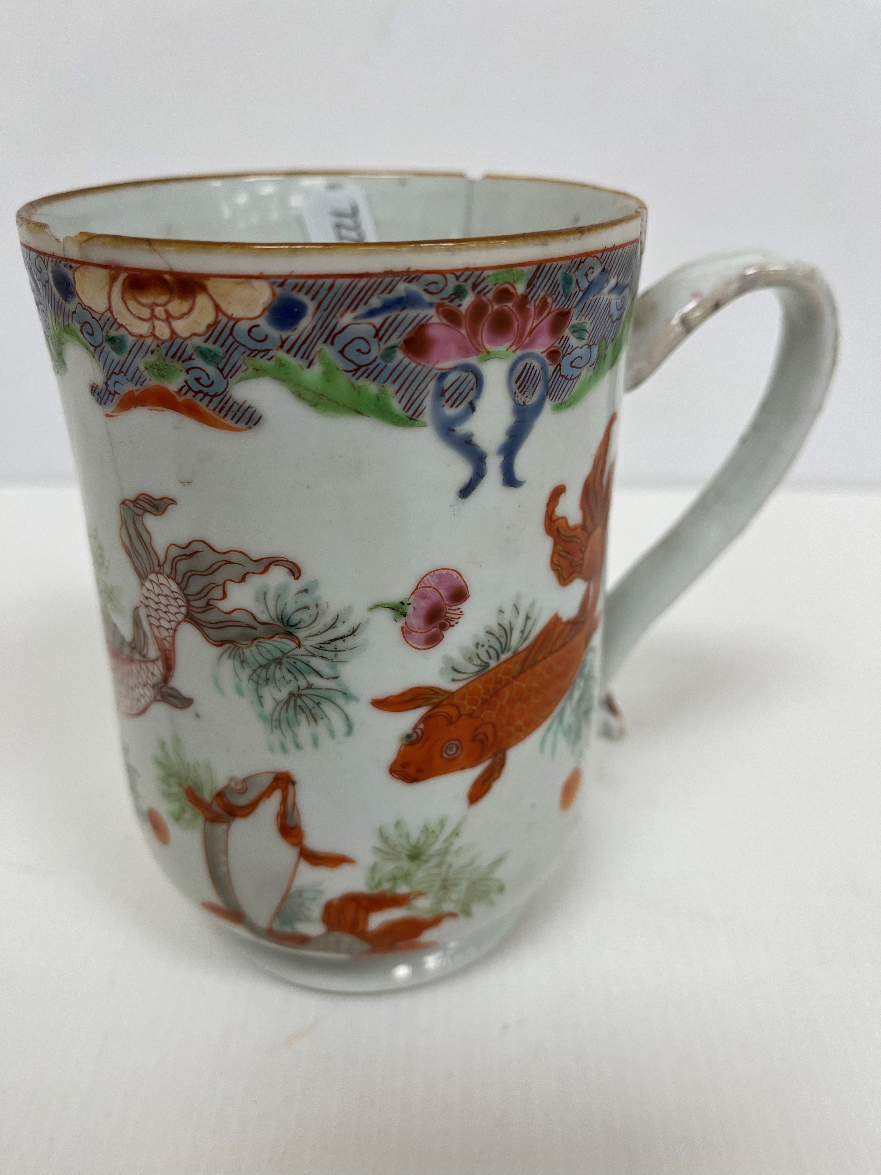 An 18th Century Chinese polychrome decorated mug of inverted bell form decorated with carp and