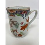 An 18th Century Chinese polychrome decorated mug of inverted bell form decorated with carp and