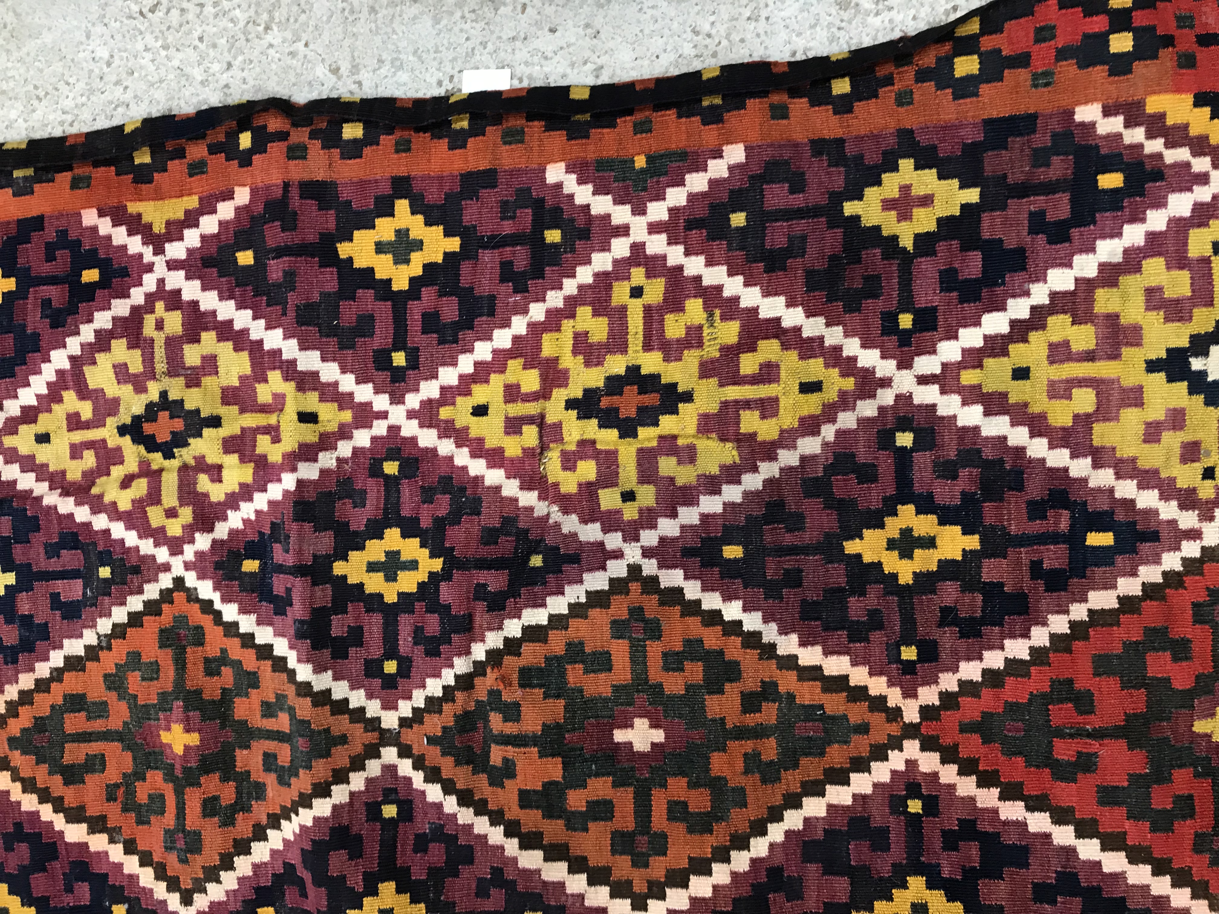 A Kelim rug, the central panel set with all-over lozenge decoration on a purple and orange ground, - Image 3 of 12