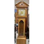A modern light oak cased long case clock,