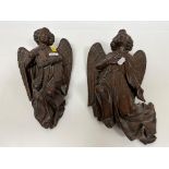Two carved oak wall mounted angel figures, one carrying an incense burner, 30 cm and 28.