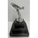 A Spirit of Ecstasy style chrome figure, raised on three tier granite base, as a paperweight,