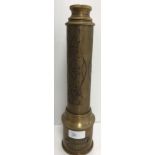 A reproduction brass three draw telescope with engraved decoration and label inscribed "Royal Navy