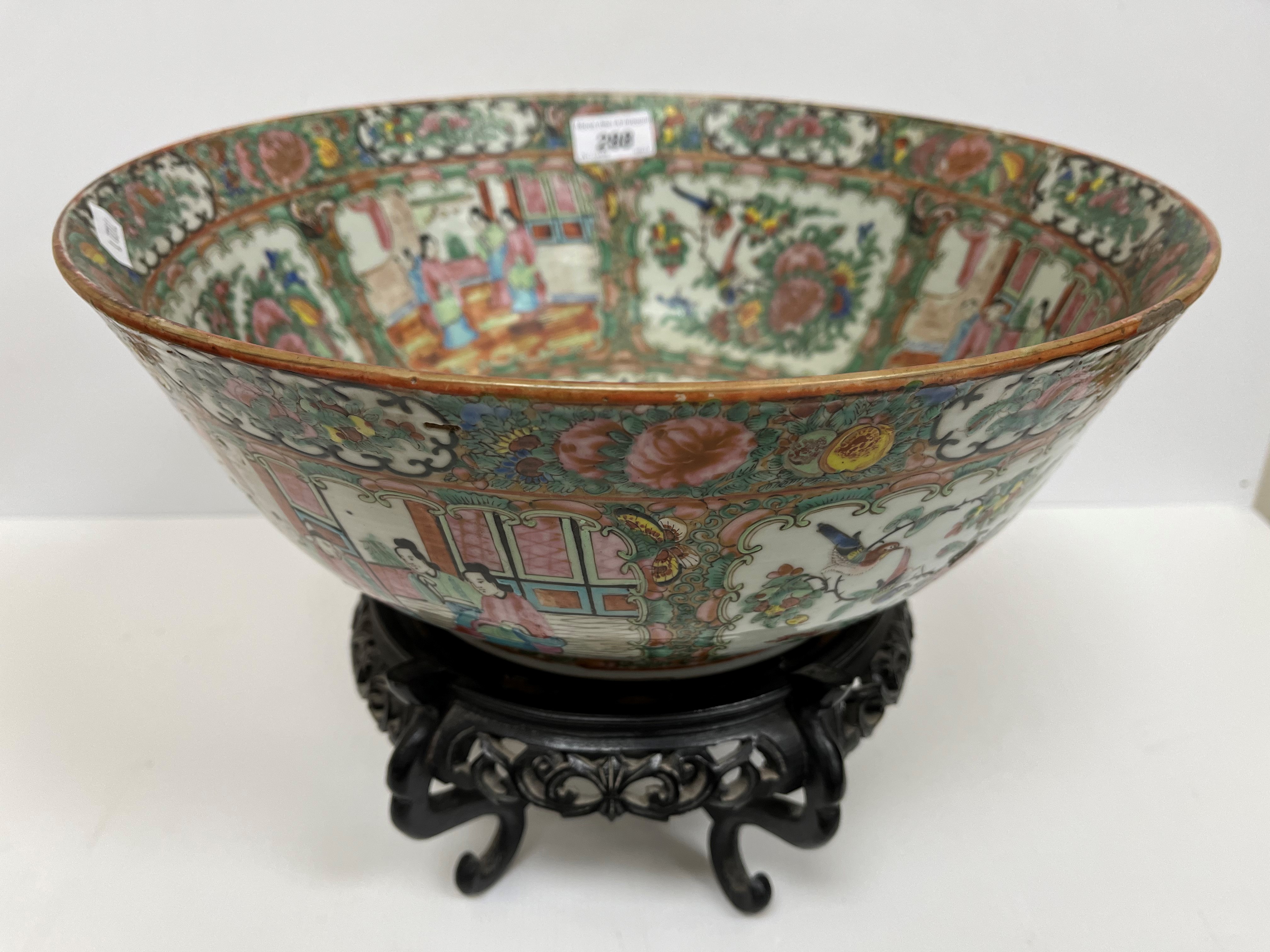 A 19th Century Chinese famille rose fruit bowl with slightly flared rim and carved wooden stand,
