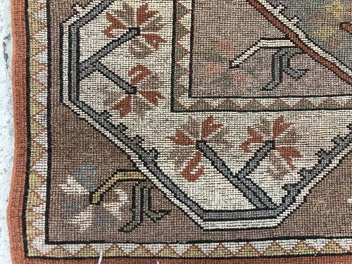 A Caucasian rug, the central panel set with five repeating medallions on a salmon pink ground, - Image 13 of 13