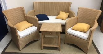 A Lloyd Loom style three piece conservatory suite of two seat sofa,