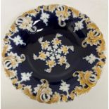 A 19th Century Meissen relief work decorated blue ground dish with scrolling gilded foliate border