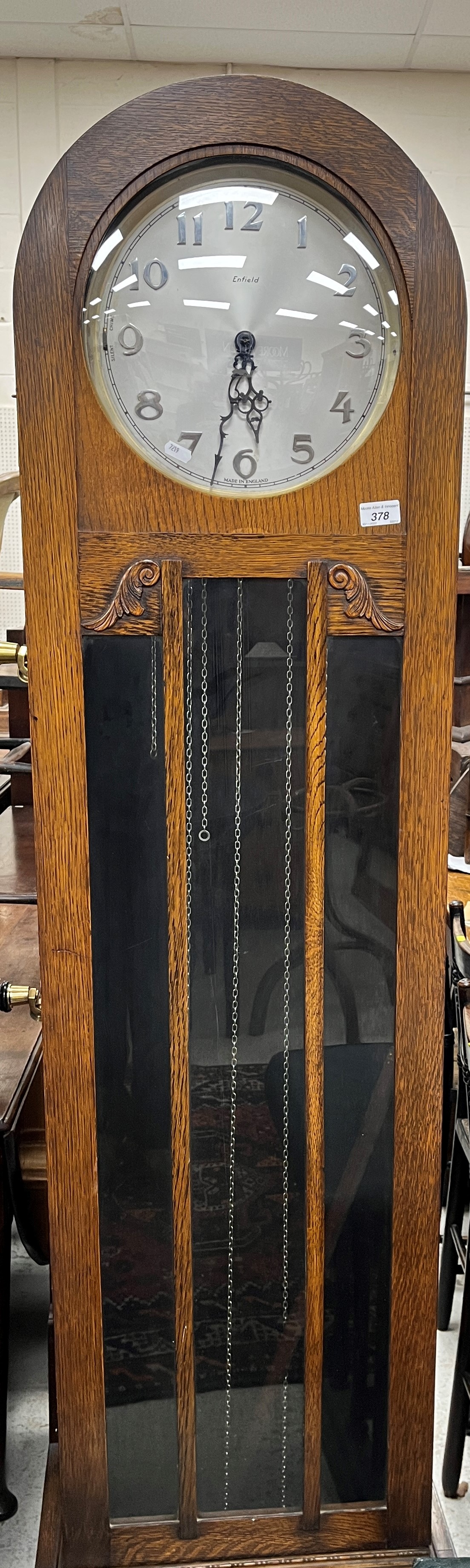 A 1930s oak cased long case clock with dome top,