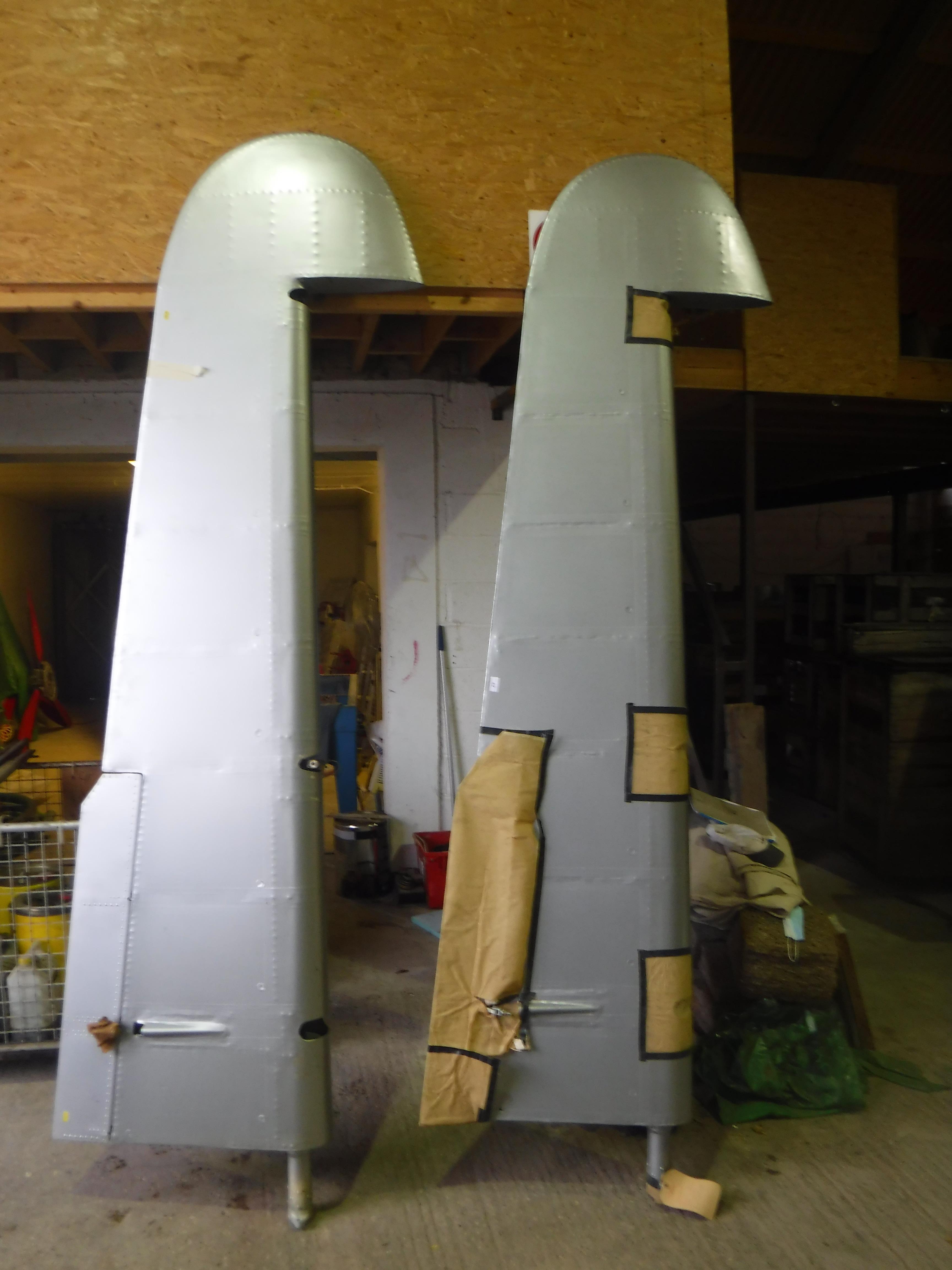 A pair of aeroplane tail elevator sections (probably Devon), silver painted, 245 cm long,