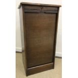 An early to mid 20th Century oak tambour front filing cabinet of nine drawers,