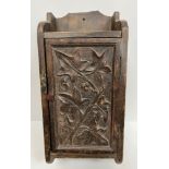 A circa 1900 carved walnut wall cupboard of small proportions,