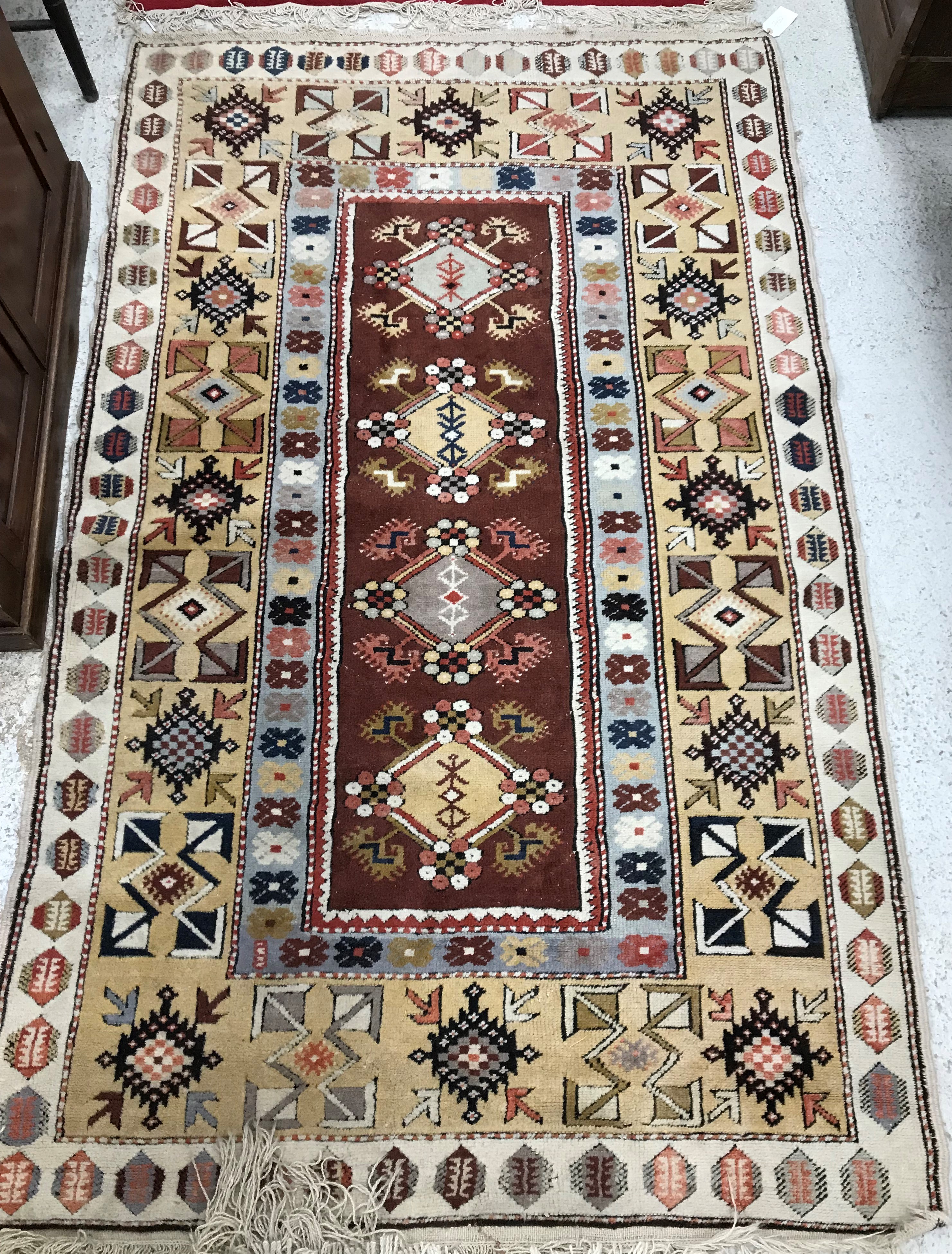 A Caucasian rug, the central panel set with five repeating medallions on a salmon pink ground, - Image 5 of 13