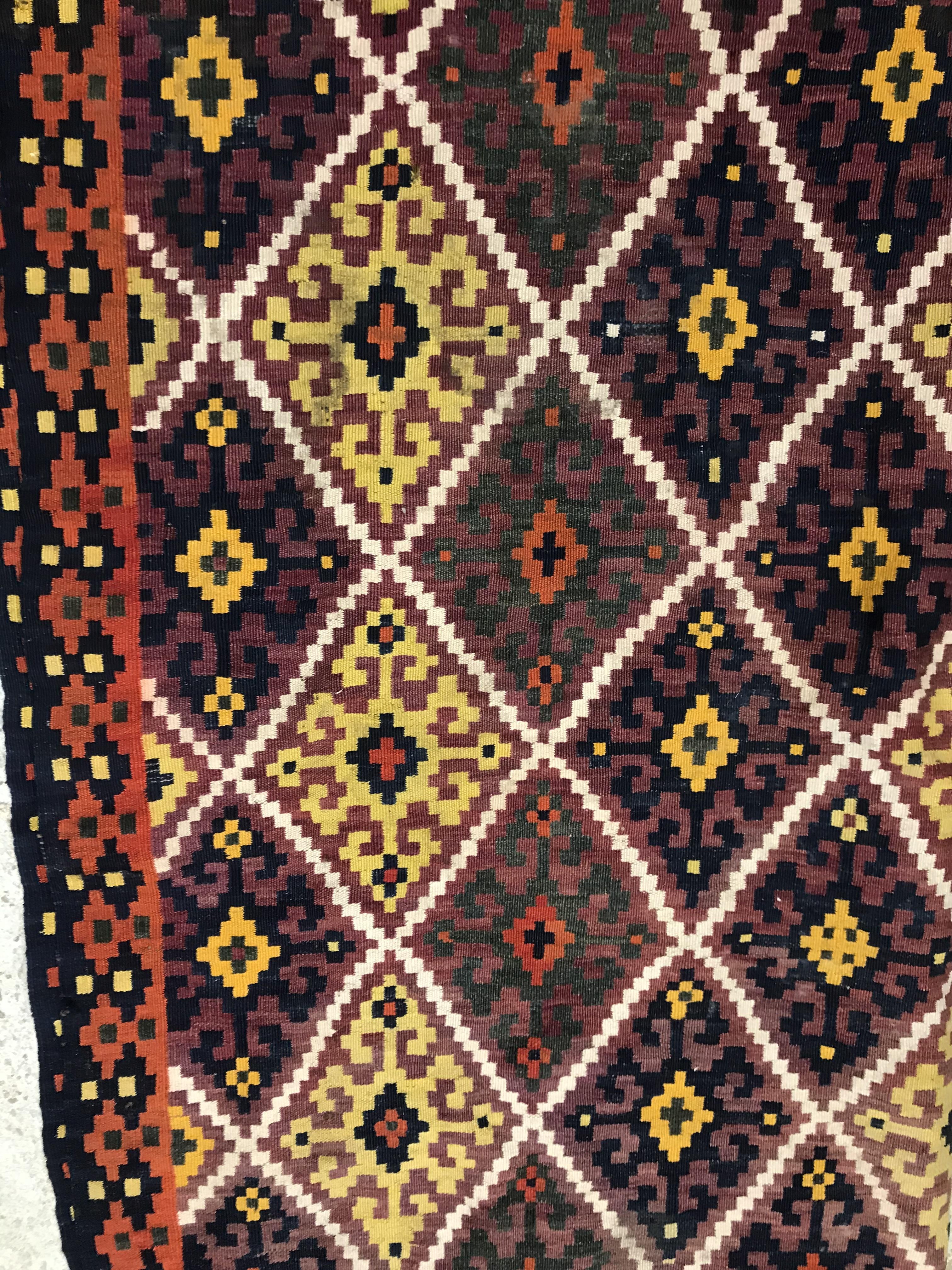 A Kelim rug, the central panel set with all-over lozenge decoration on a purple and orange ground, - Image 8 of 12