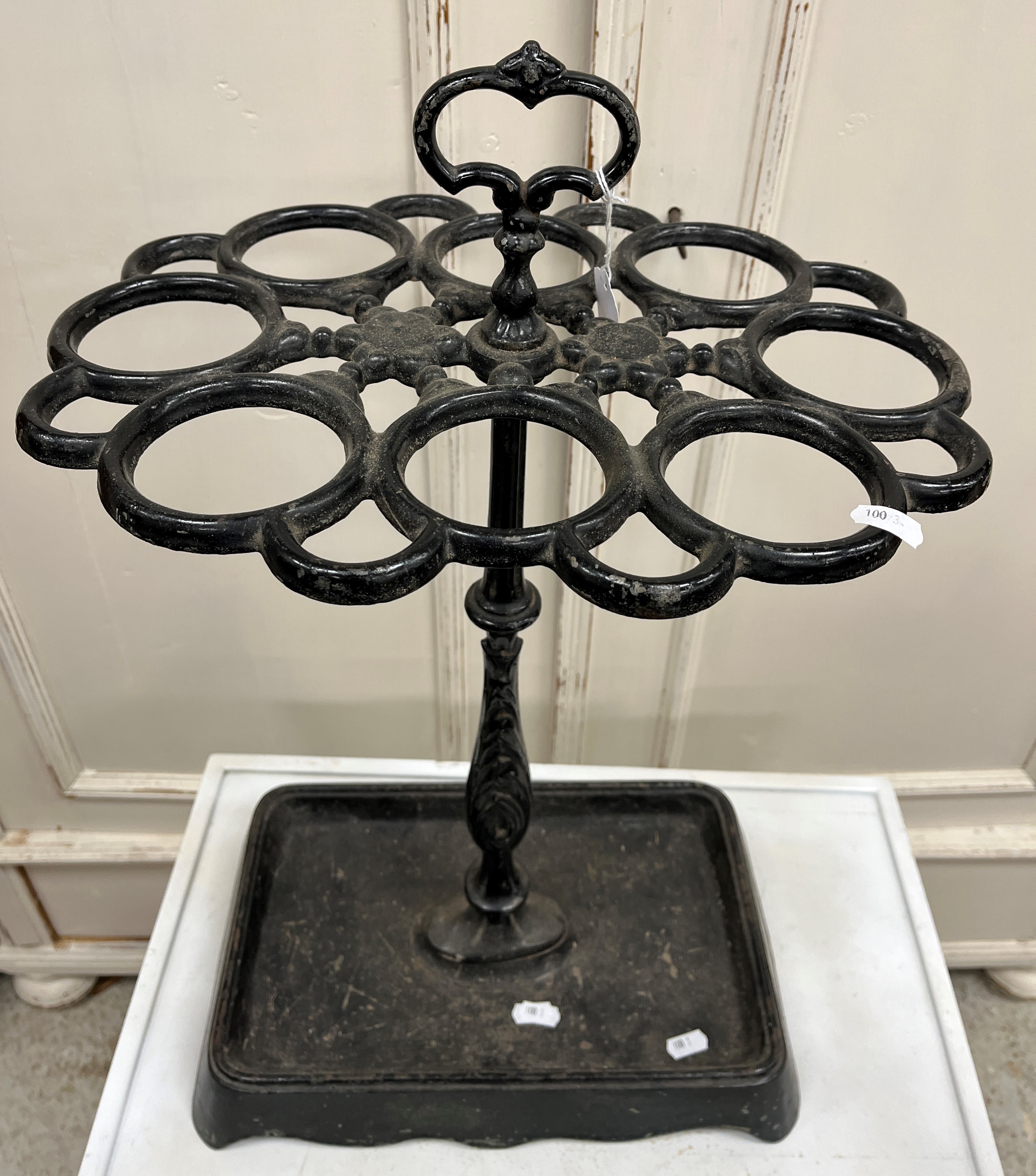A Victorian style cast iron eight section stick stand of oval form on a centre column to the