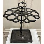 A Victorian style cast iron eight section stick stand of oval form on a centre column to the