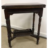 A late Victorian walnut fold over card table,
