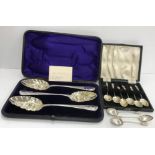 A cased set of three Georgian silver fruit spoons with later embossed decoration (two by