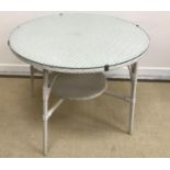 A Lloyd Loom circular white painted conservatory table with glass cover,