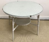 A Lloyd Loom circular white painted conservatory table with glass cover,