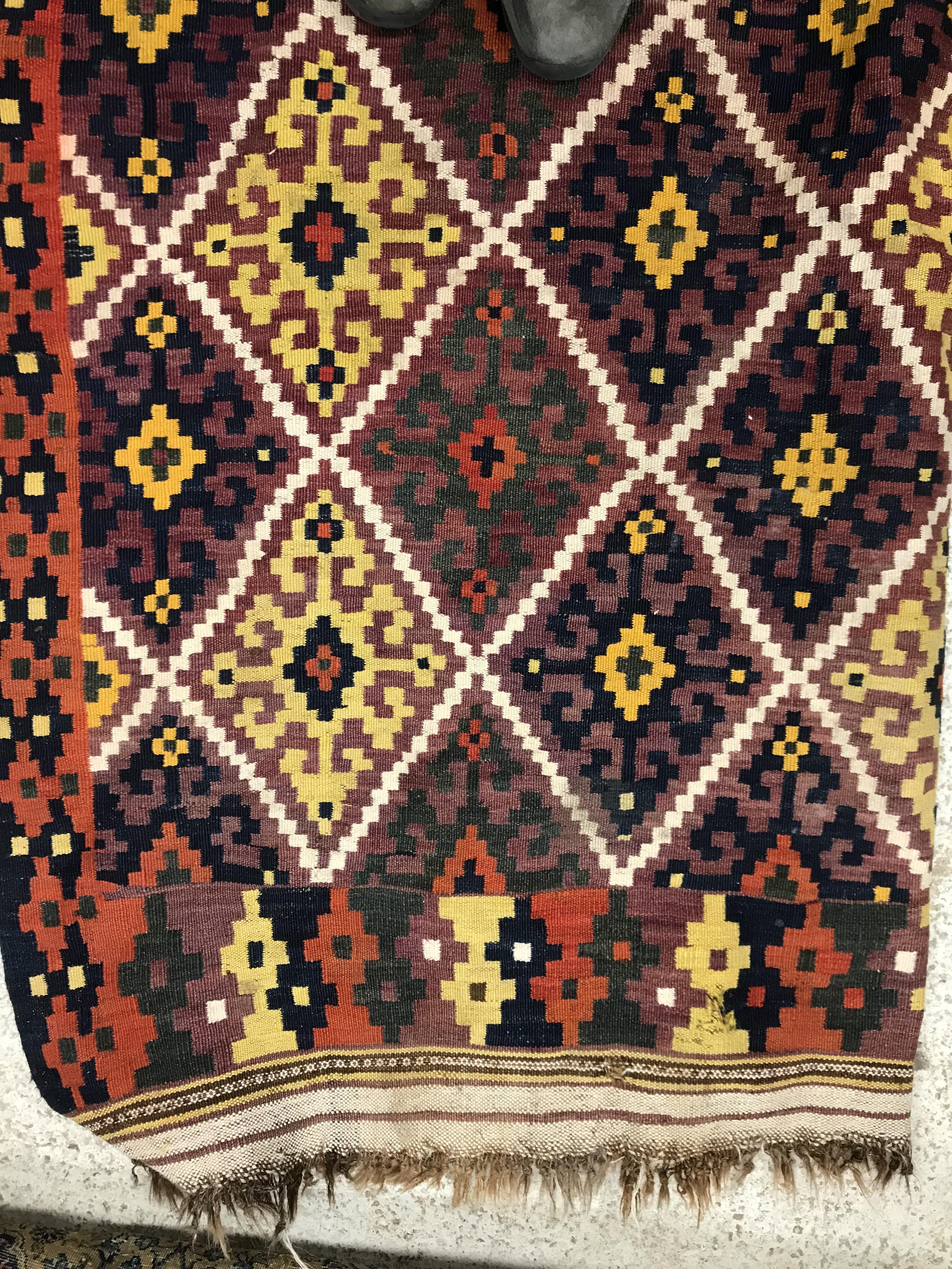 A Kelim rug, the central panel set with all-over lozenge decoration on a purple and orange ground, - Image 9 of 12