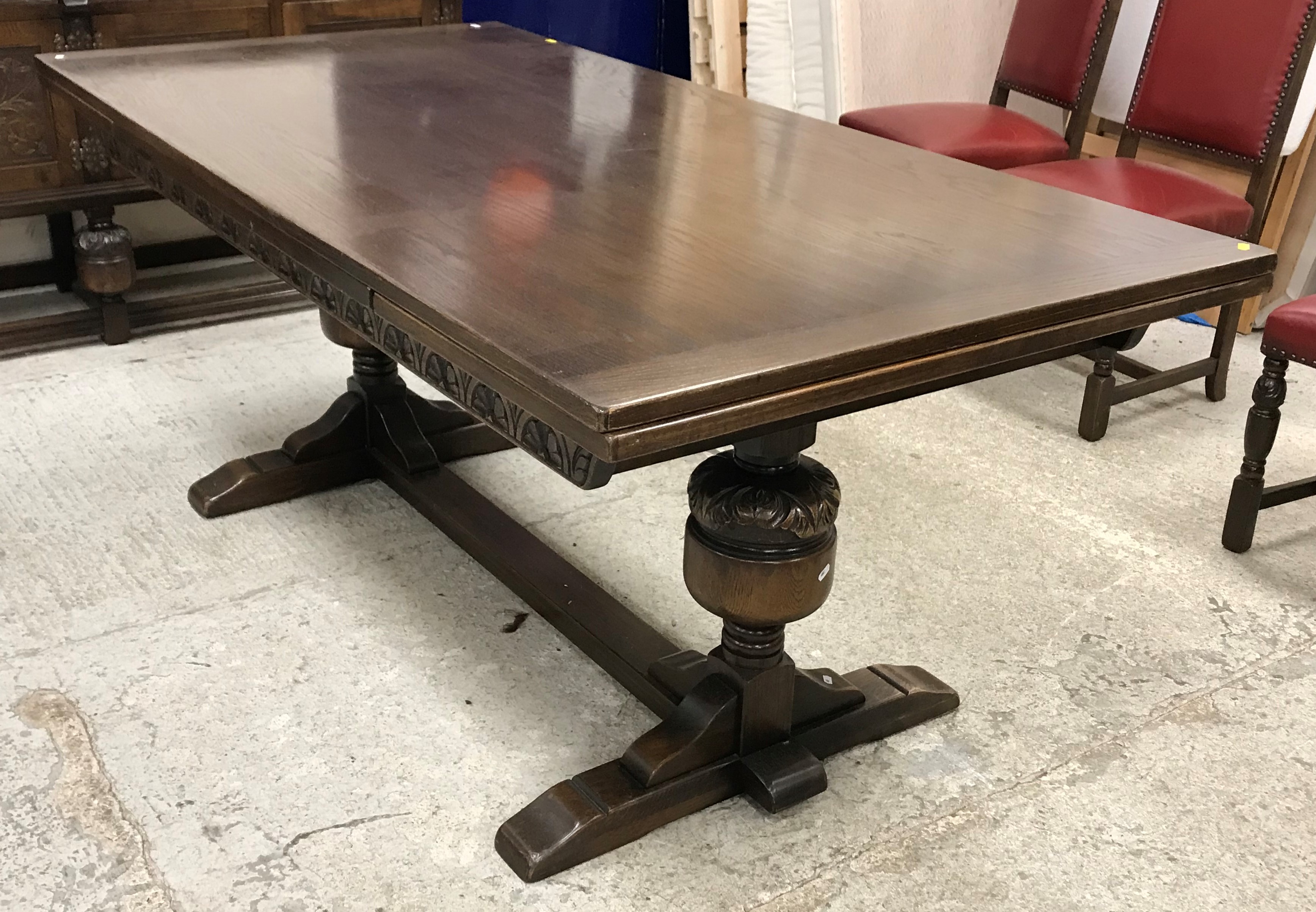 A Maple & Co oak dining room suite comprising carved oak drawer leaf table in the 17th Century