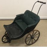 A 20th Century faux leather buttoned child's pram/pushalong buggy with wooden footboard and iron