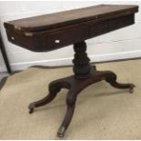 A 19th Century mahogany and rosewood cross banded fold over card table on turned ringed and