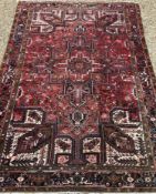 A large Heriz rug, the central panel set