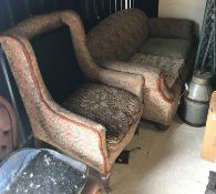 A circa 1900 drop arm sofa, raised on bu