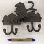 Two modern cast metal coat hooks inscrib