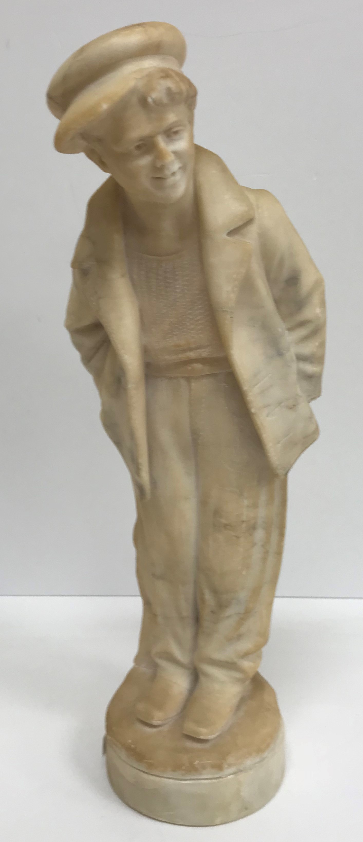 A carved alabaster figure of a young sai