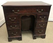 A George III mahogany kneehole desk, the