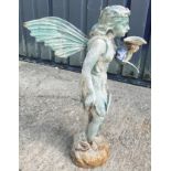 A cast metal figure of a fairy holding a