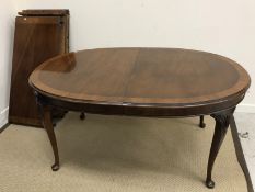 A mahogany and cross banded D end dining table in the Georgian manner raised on shell carved