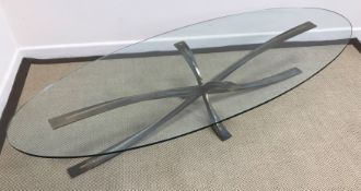 A bronze 'Spider' coffee table with oval glass top designed by Michel Mangematin and Roger Bruny,