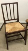 An Edwardian mahogany slat back rush seated Edward VII Coronation chair by Glenister of Wycombe,