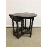 An 18th Century oak oval gate-leg drop-leaf tea table,