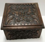 A 19th Century carved oak box with all over prunus blossom decoration,