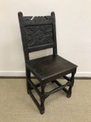 A 17th Century and later oak chair, the lozenge carved back within foliate carved stiles,