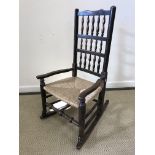 A 19th Century North Country spindle back rush seat rocking elbow chair,
