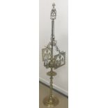 An unusual Middle Eastern brass eight light adjustable lamp with various integral accoutrements